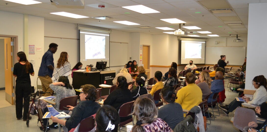 The room and those that attended the share back event listening to the moderator explain the analysis of data.