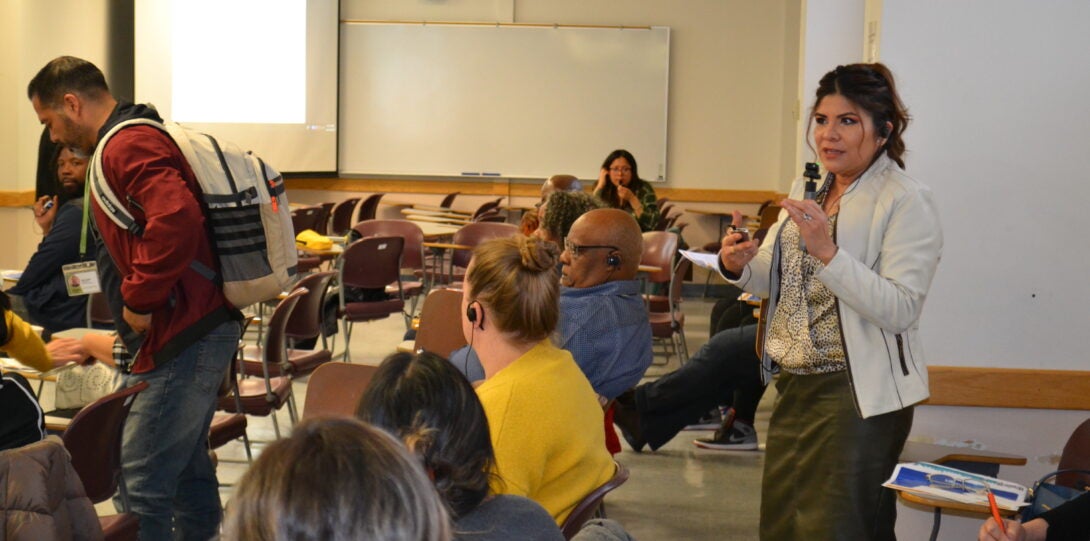 A Greater Lawndale community member speaking to other attendees of the share back event.