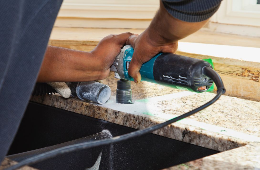 Person working with fabricated stone countertop